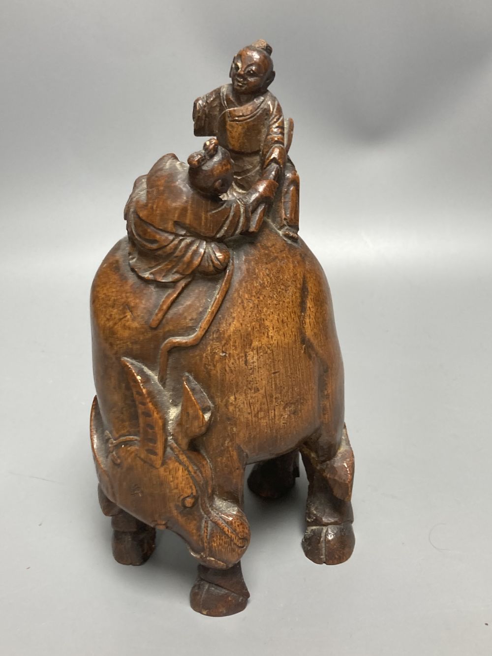 A Chinese bamboo group of figures on an ox and a wrist rest, 23 and 17cm